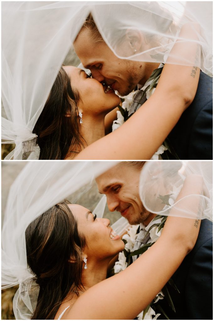 bride and groom kissing under veil, bride and groom wearing leis