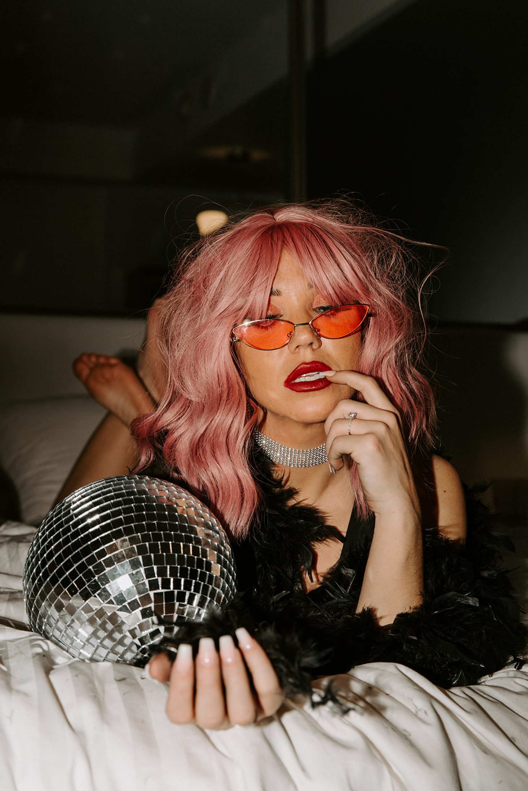 girl in pink wig and holding disco ball