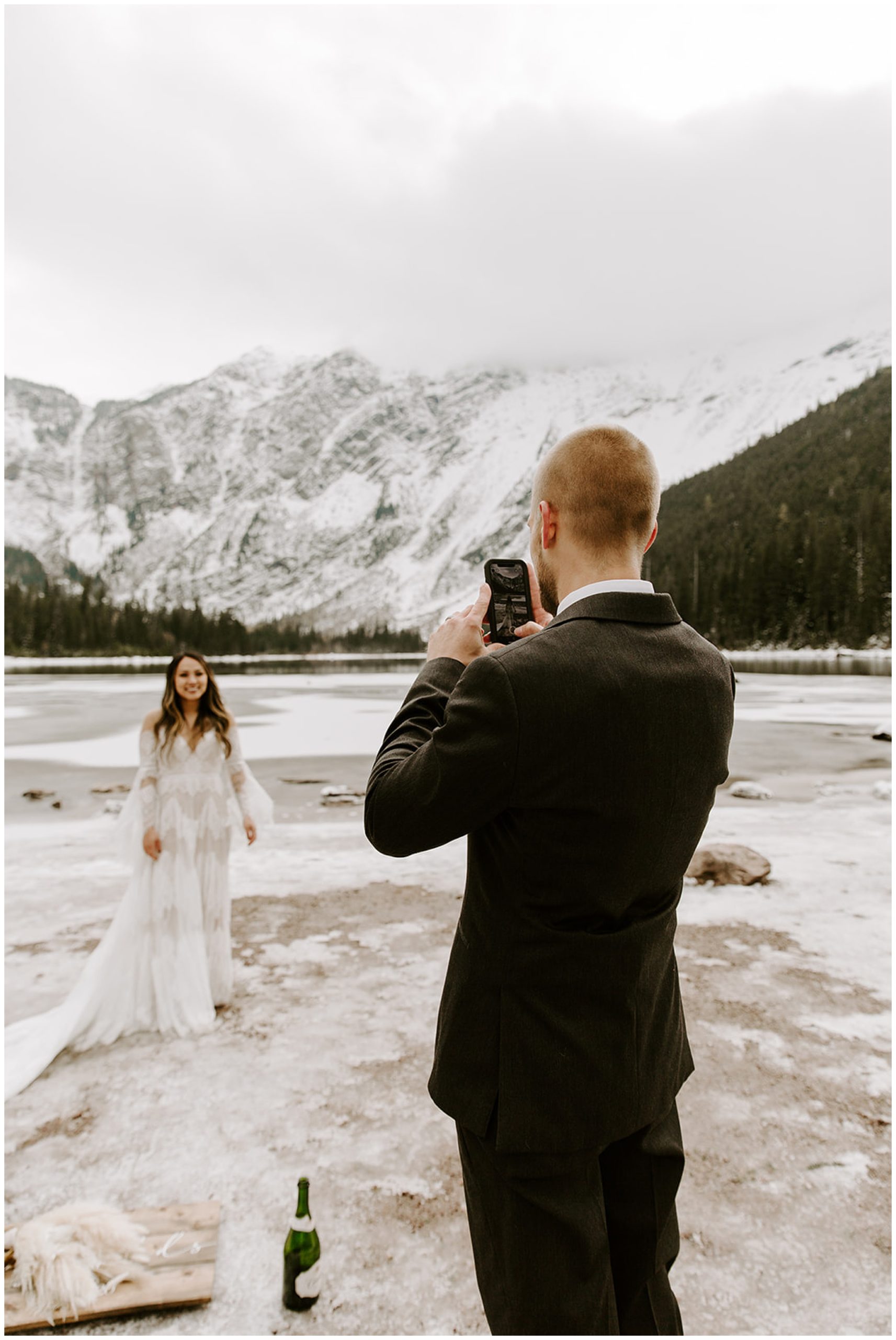 groom taking picture of bride on phone