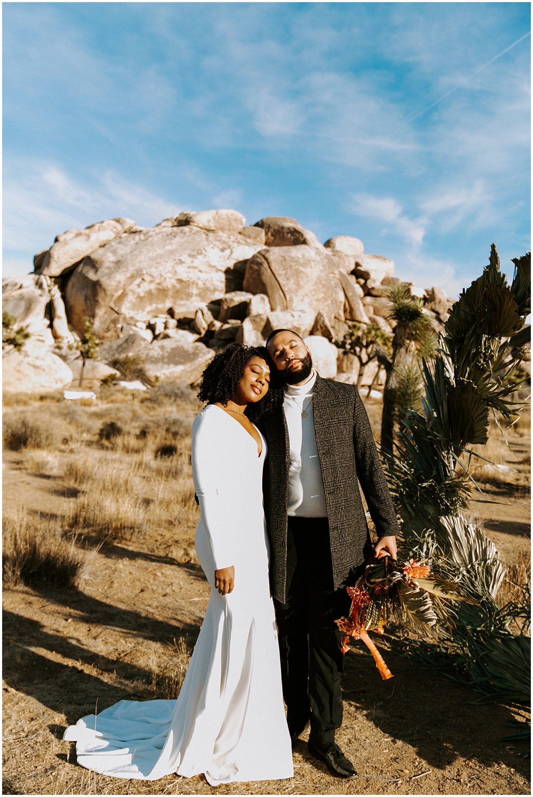 bride and groom posing in desert