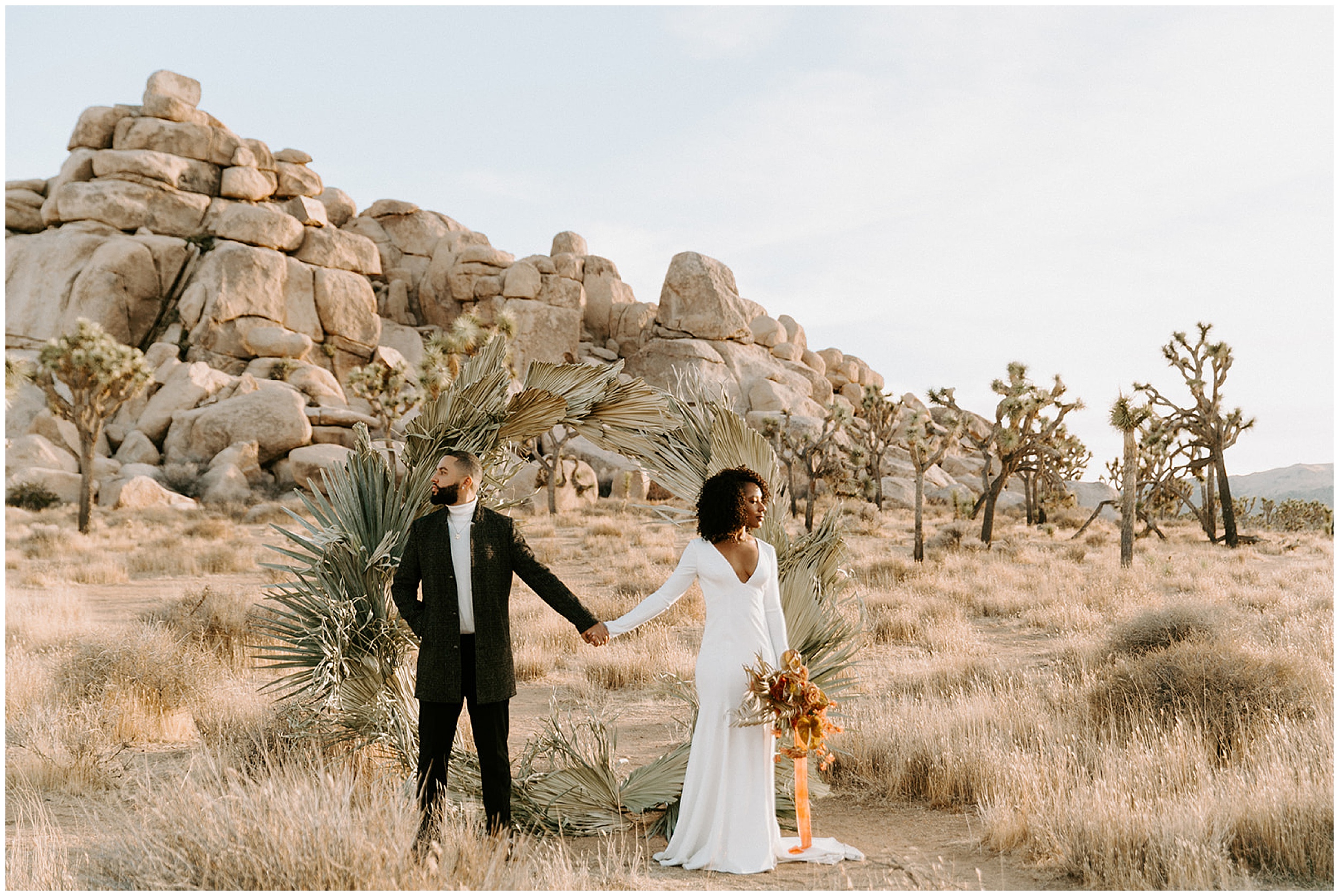 bride and groom standing in joshua tree national park