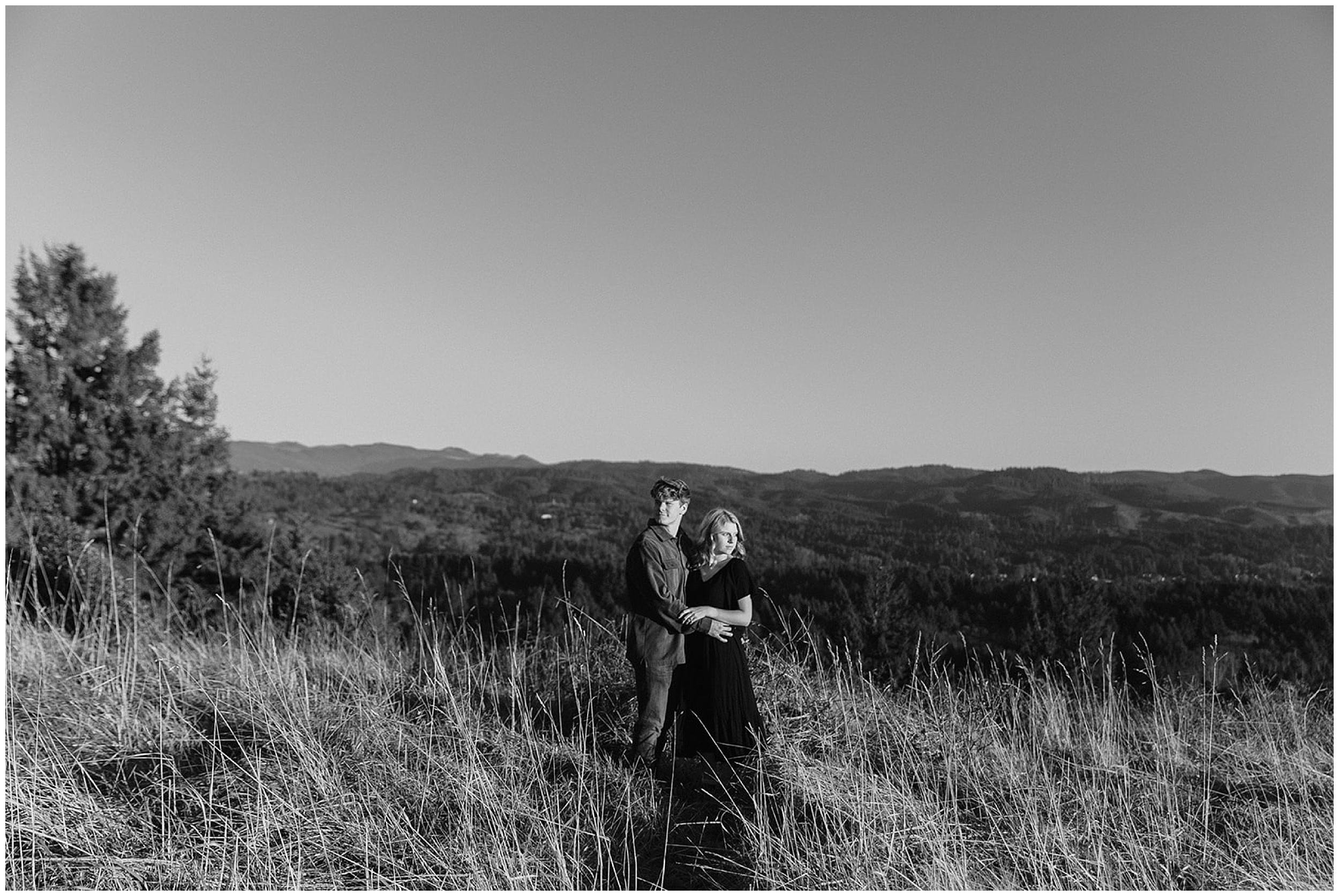 couple standing in tall grass