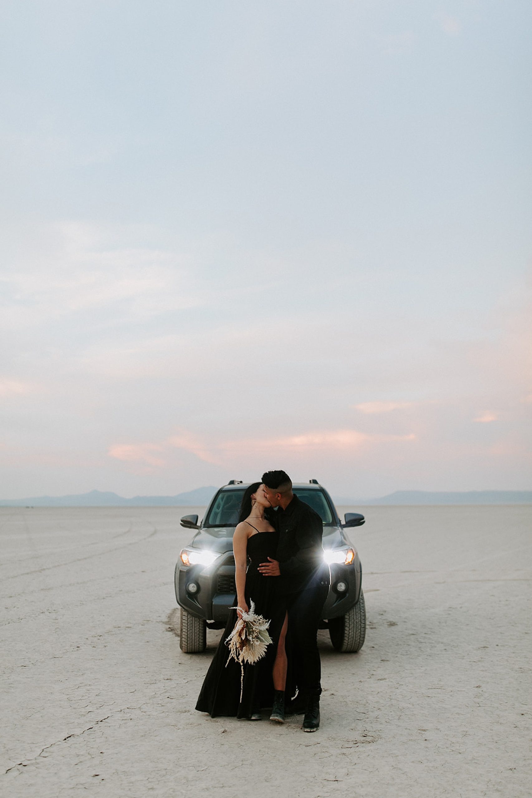 couple standing in front of car