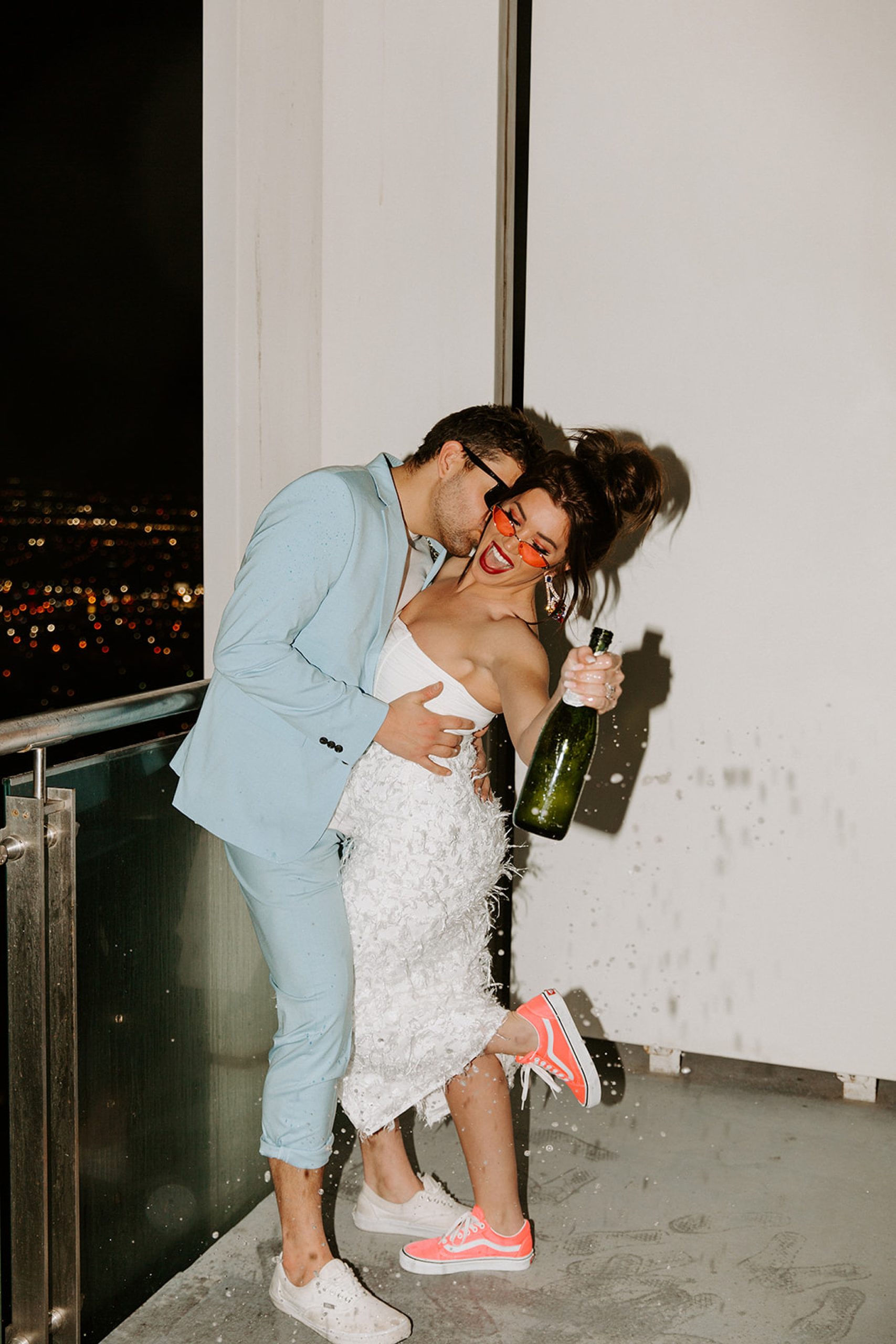 bride and groom holding champagne
