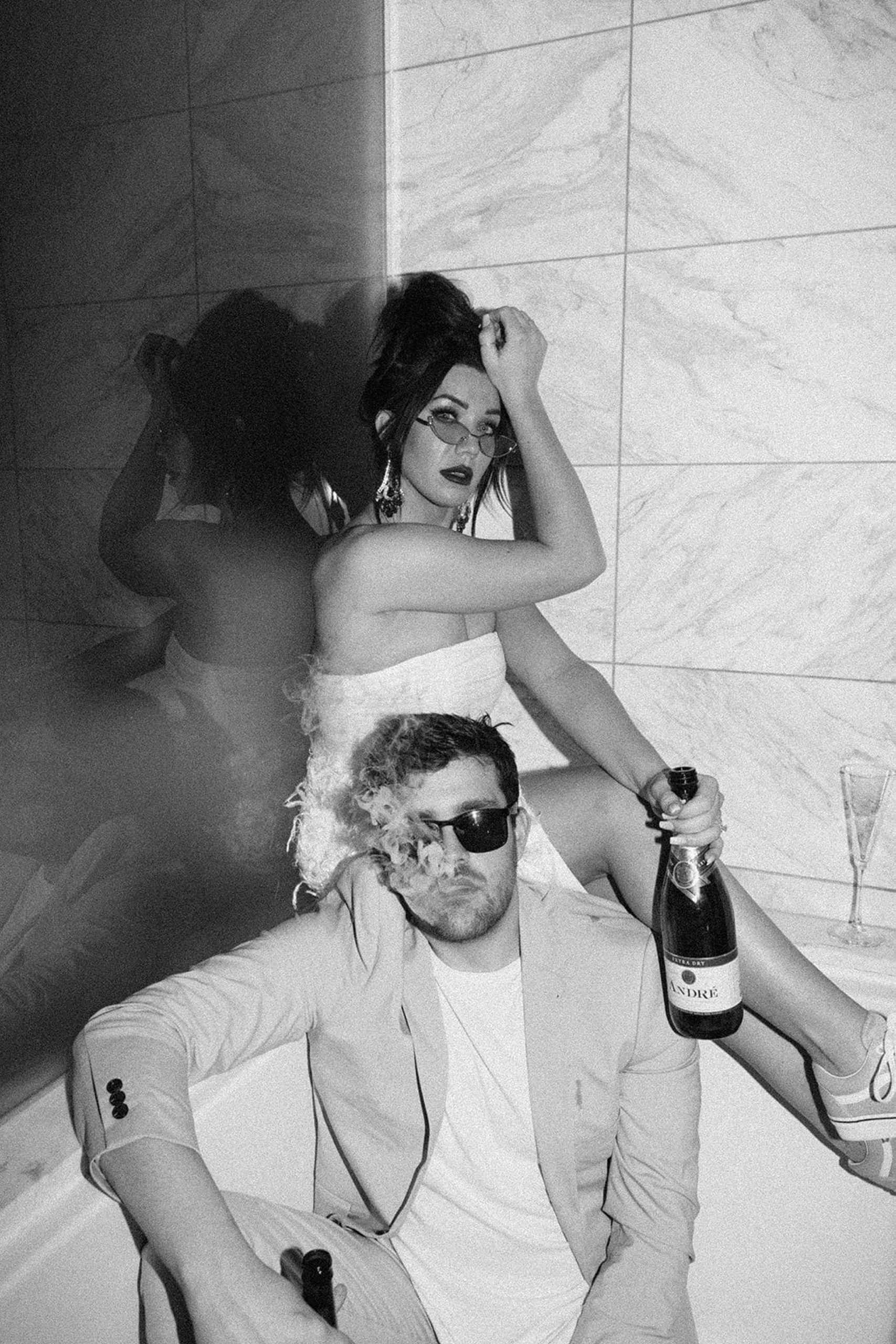 bride and groom sitting in bathtub and smoking