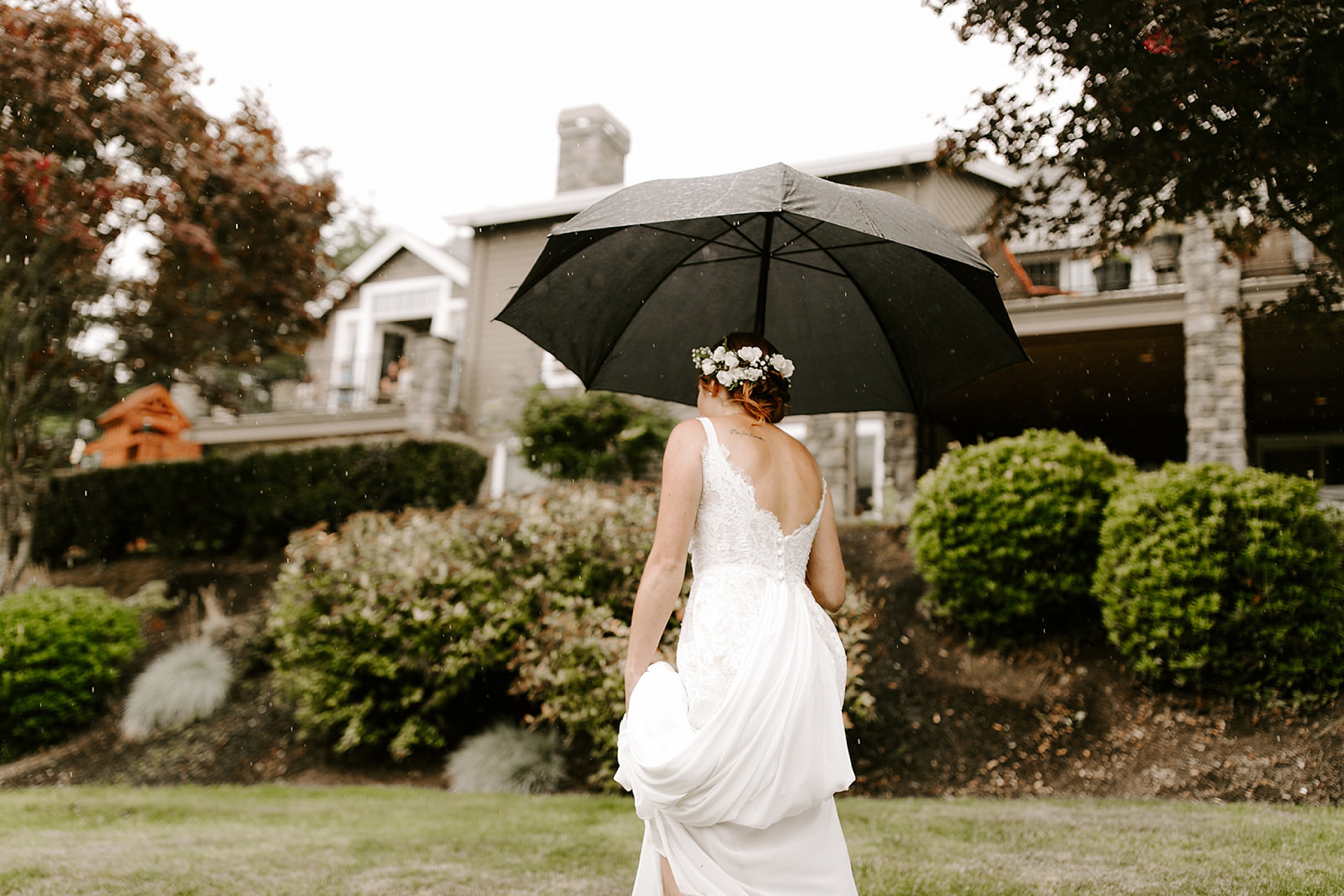 bride holding umbrella and walking