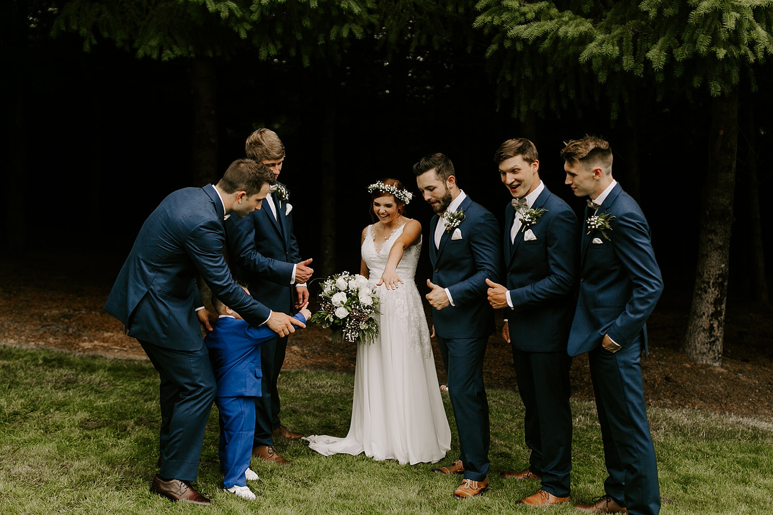groomsmen looking at bride's ring