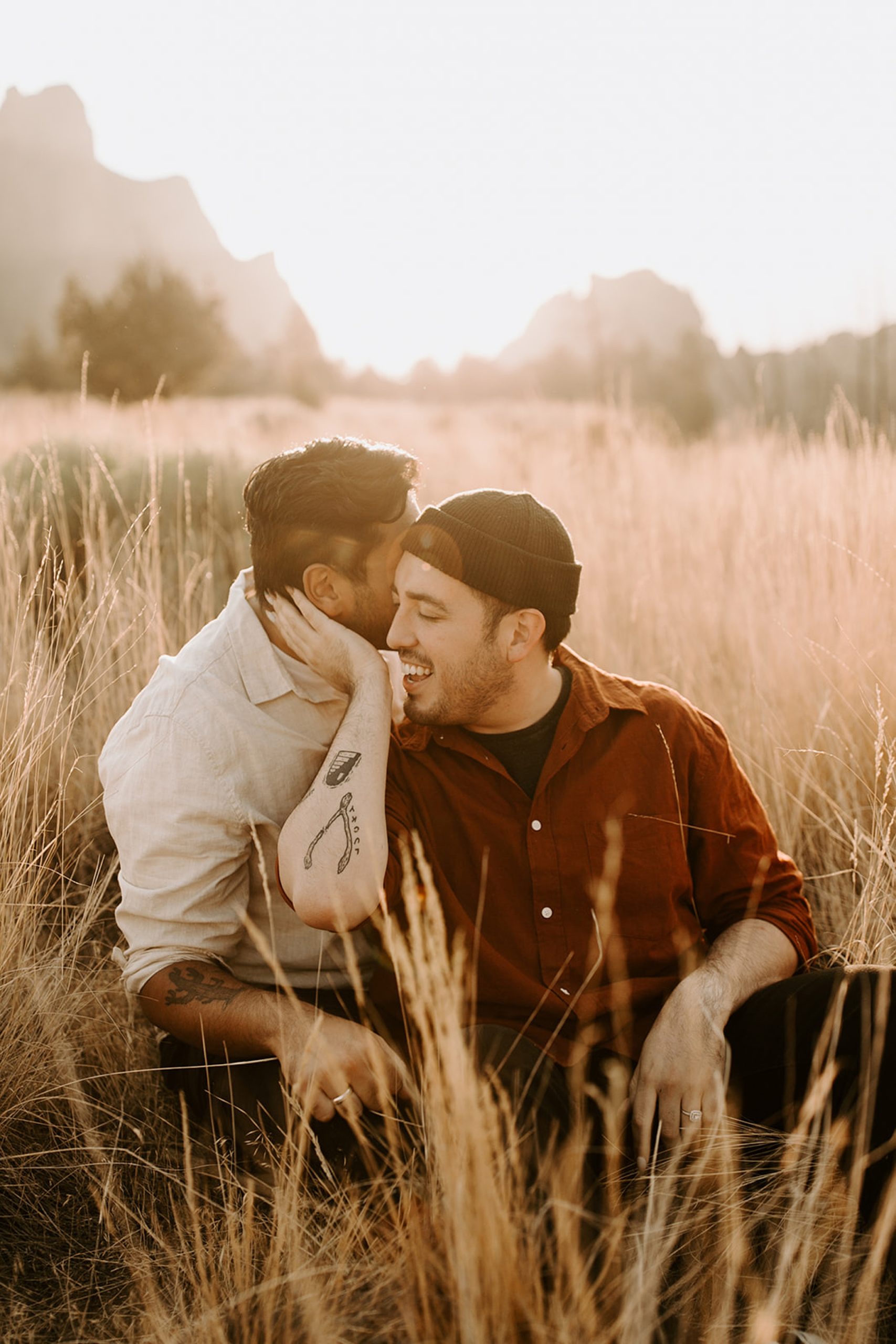 couple snuggling in tall grass