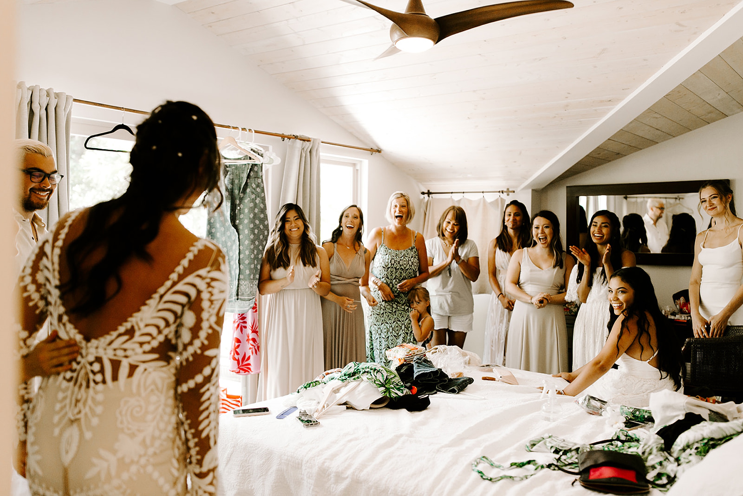 bridesmaids seeing bride in wedding dress