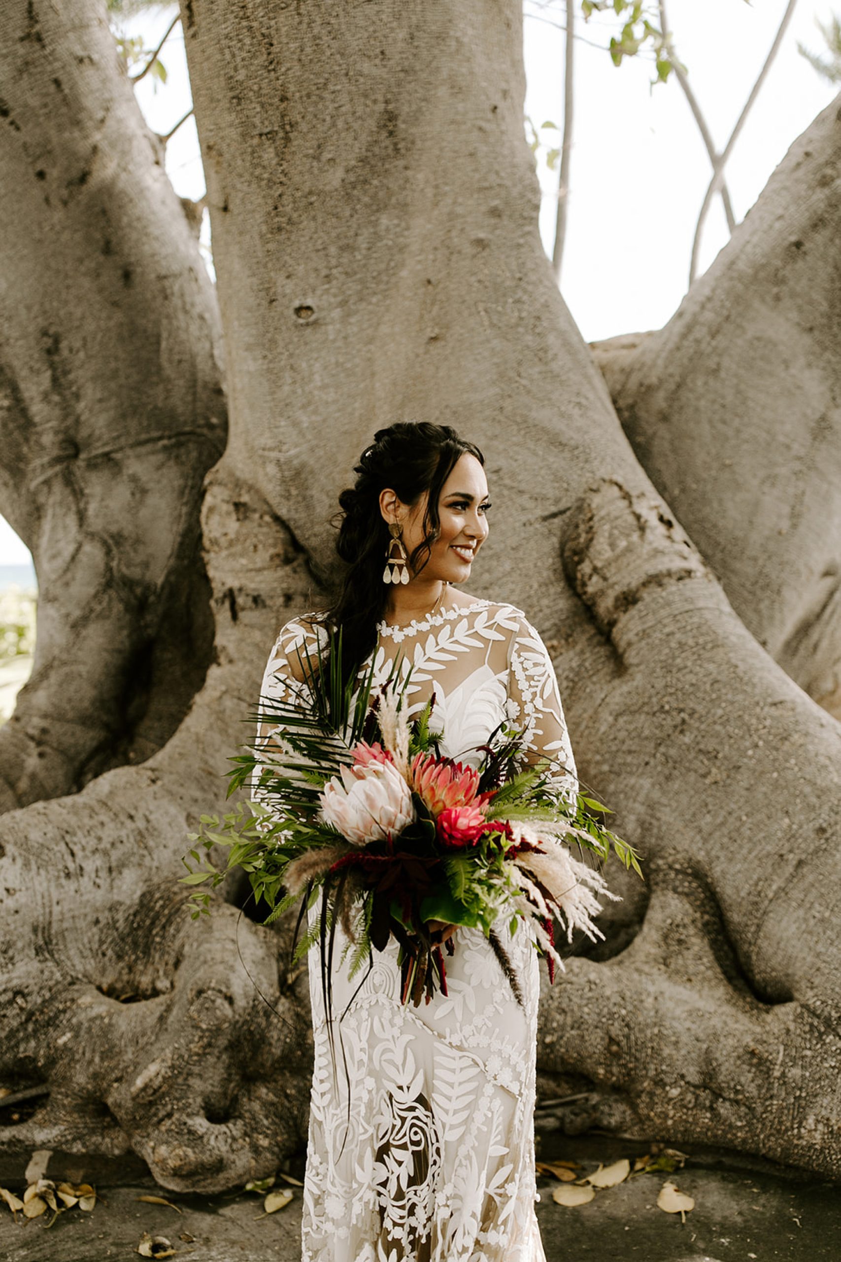 bride holding tropical bouquet