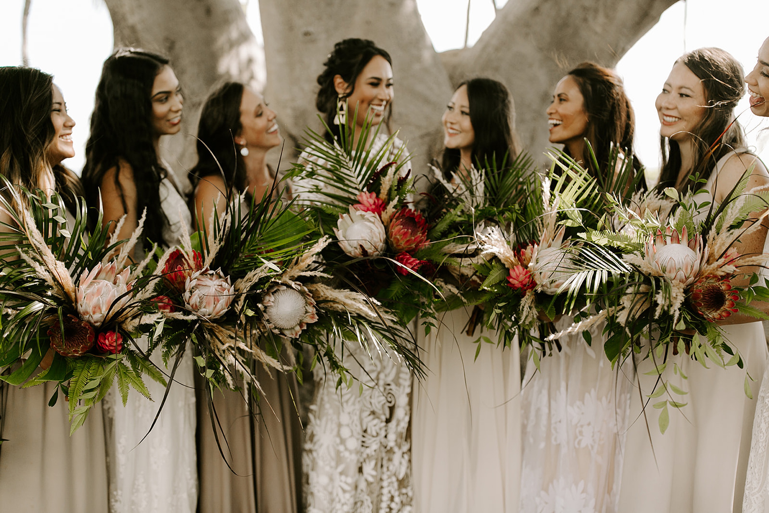 bridesmaids holding tropical bouquets
