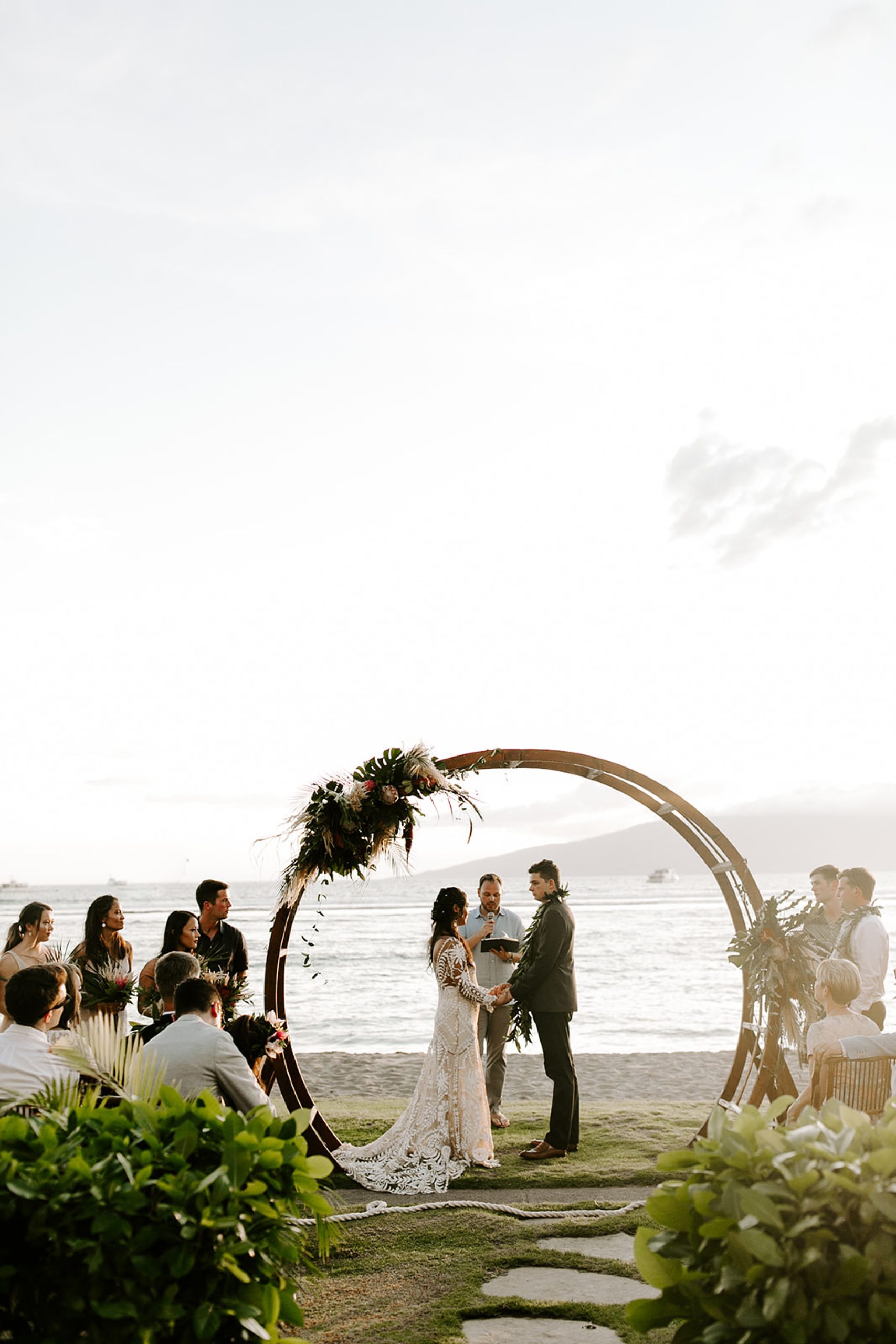 bride and groom under wedding arbor