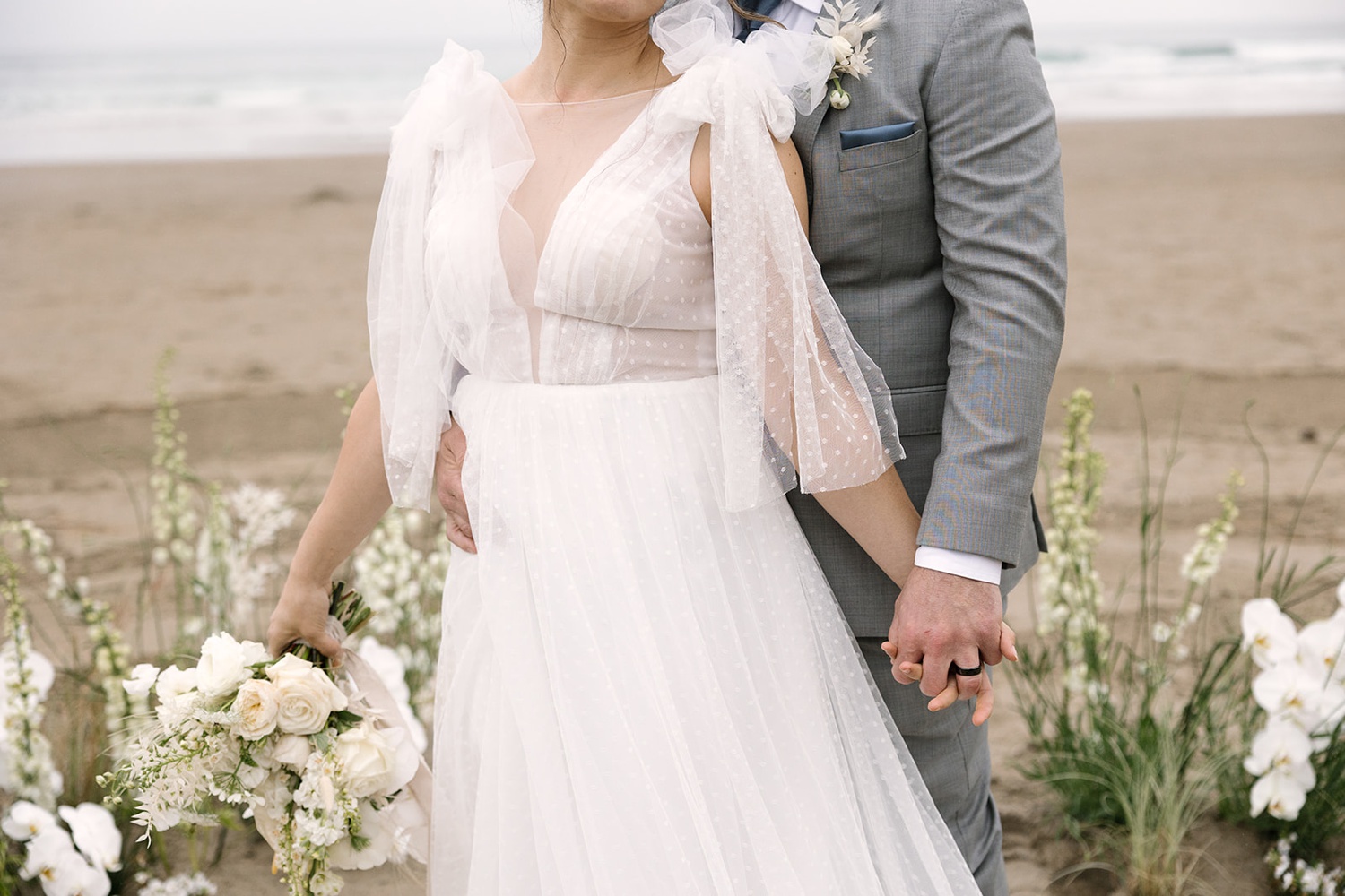 bride in her white gown and groom in his grey tux at their Oregon coast elopement