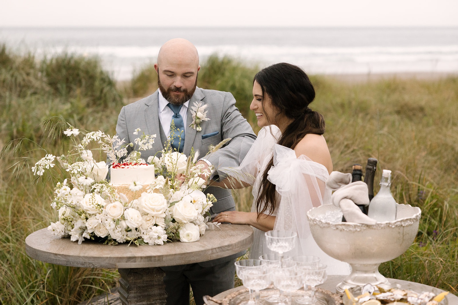 bride and groom cutting their cake at their oregon coast elopement