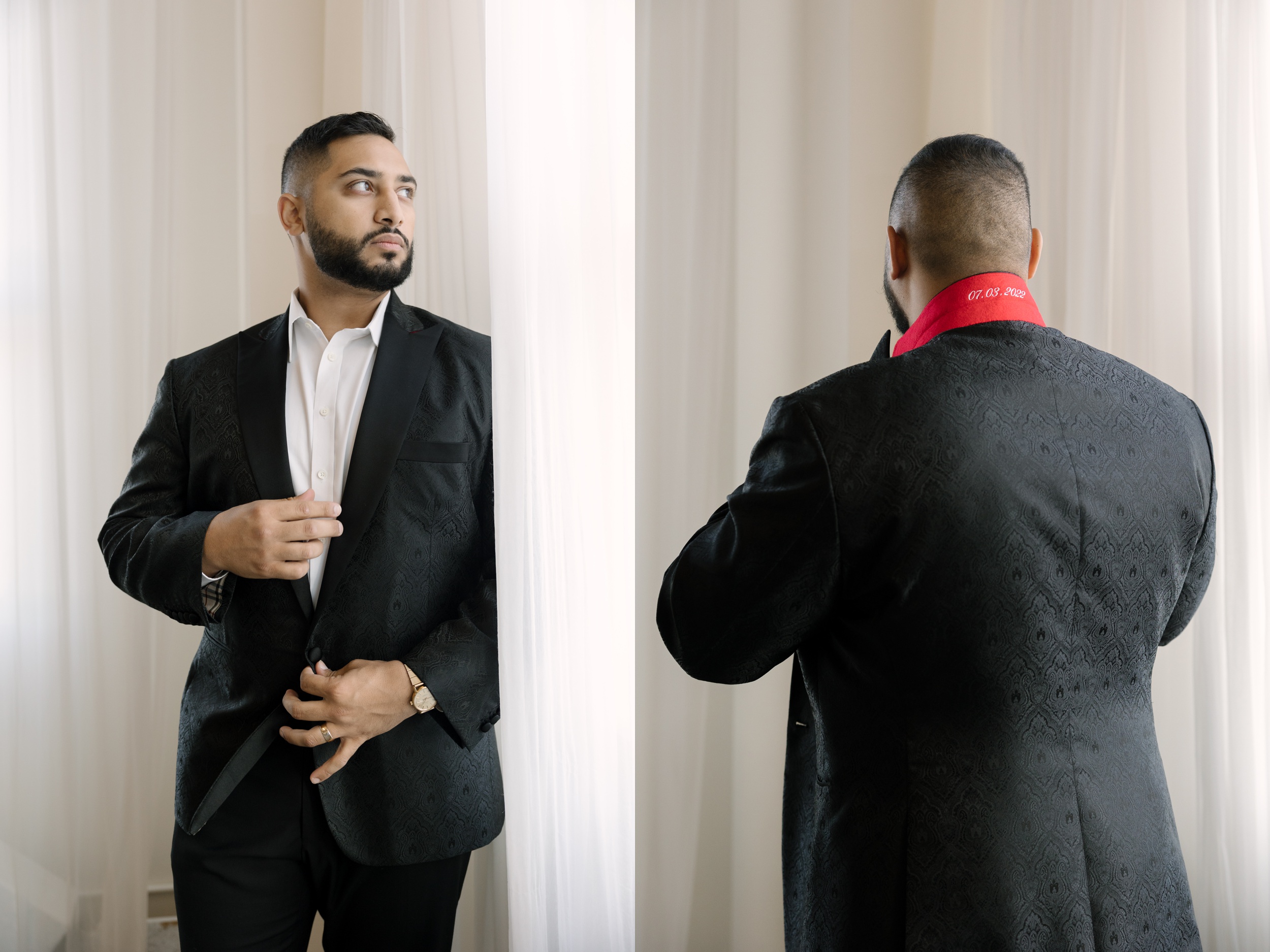 man in a black suite posing for a studio wedding photoshoot