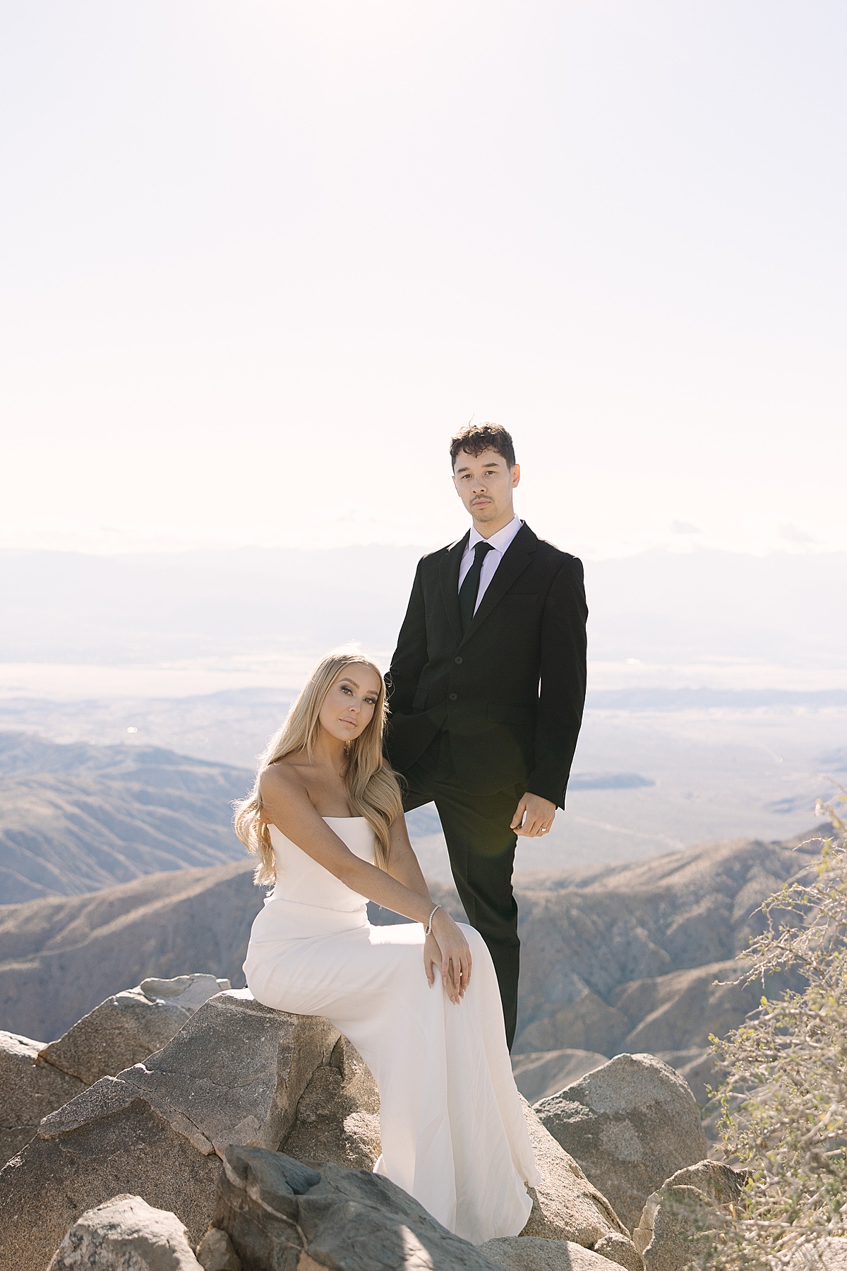 a bride in a white gown and groom in an all black suit at their Joshua Tree elopement